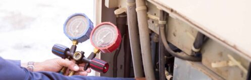 Licensed HVAC technician inspecting AC refrigerant lines in a Paradise NV home