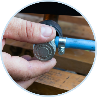 Technician from local gas line repair company adjusting residential gas valve